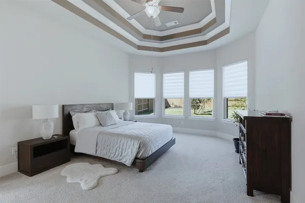 a spacious bedroom with a bed and window