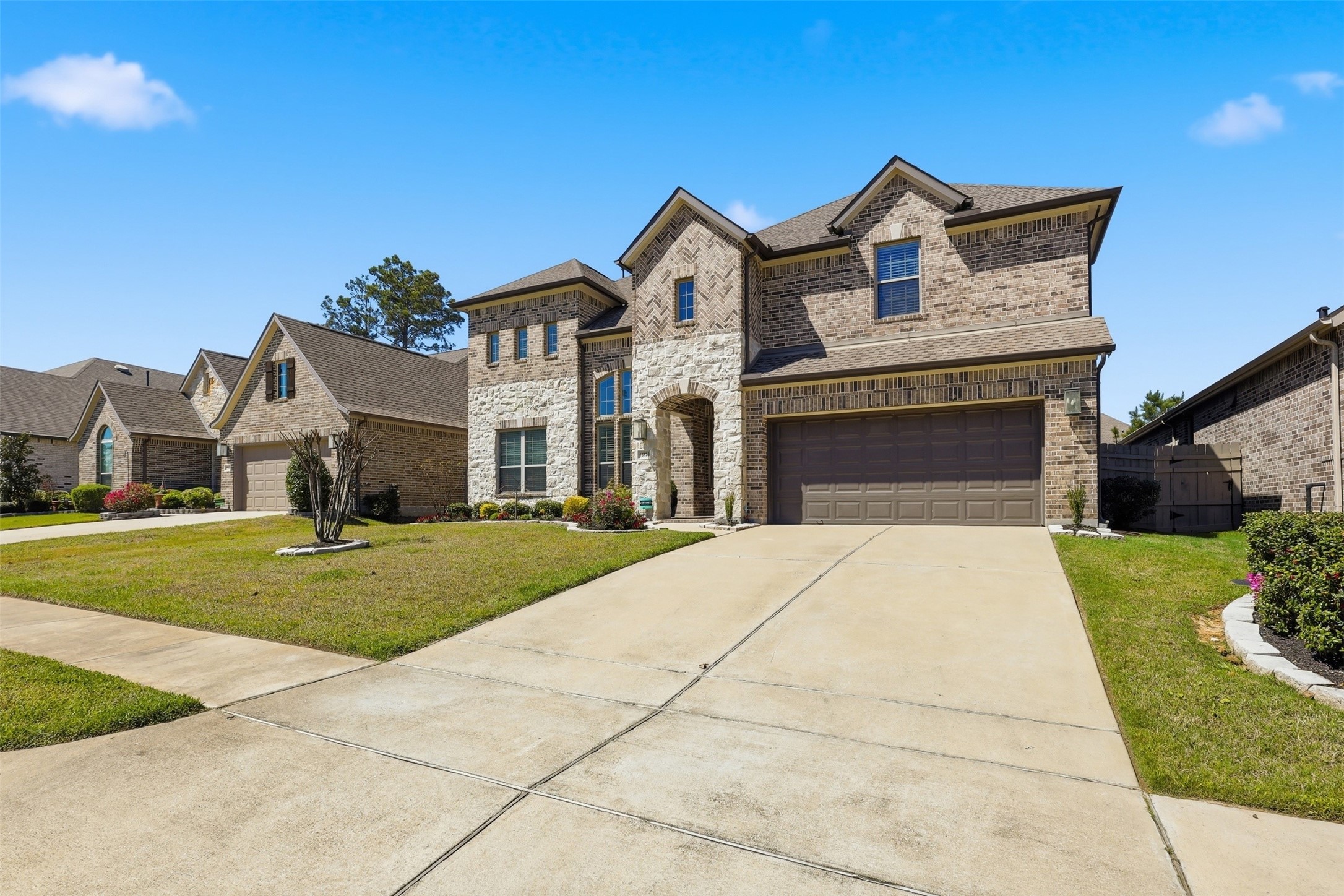 15133 Mahogany Trail Conroe, TX 77302 - Photo 2 of 49 a front view of a house with a yard and garage