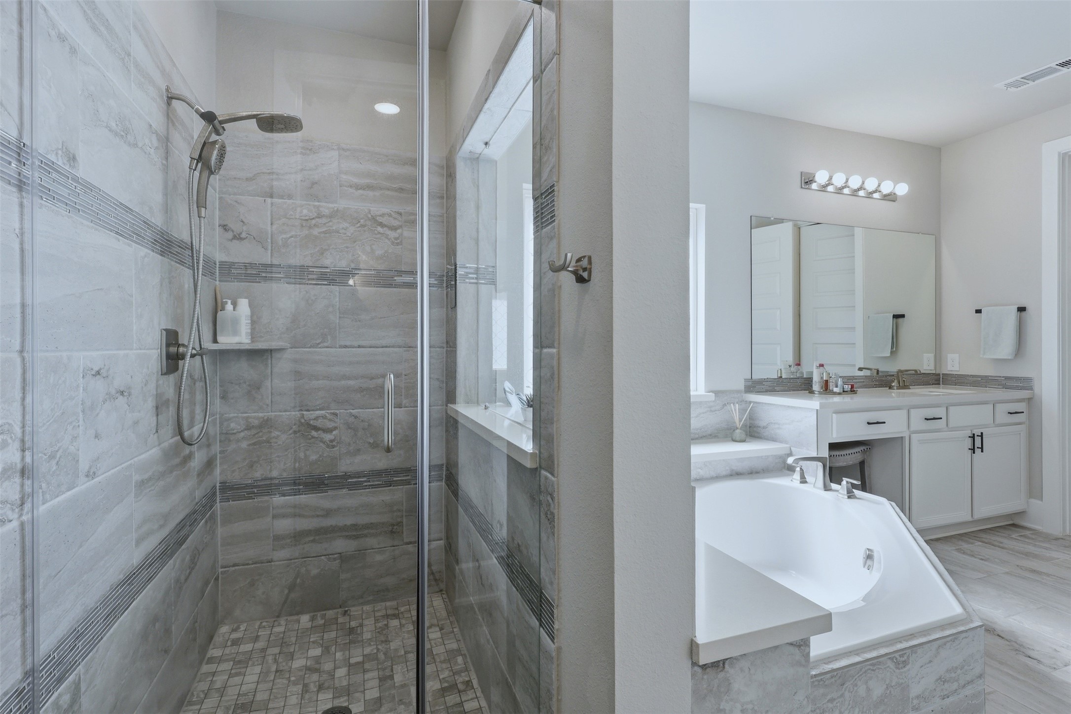 15133 Mahogany Trail Conroe, TX 77302 - Photo 23 of 49 a bathroom with a double vanity sink a toilet and shower