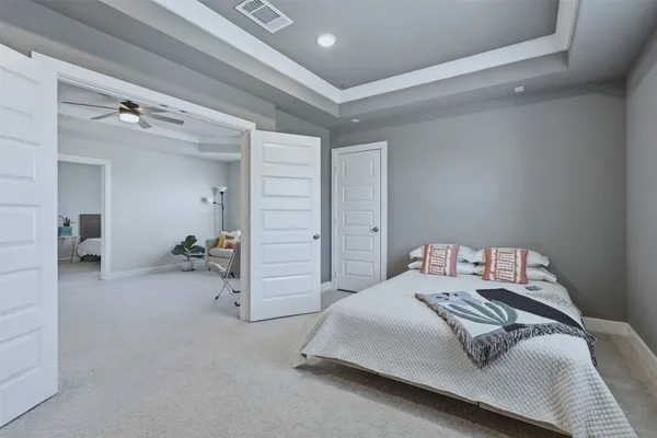 a bedroom with a bed and cabinets