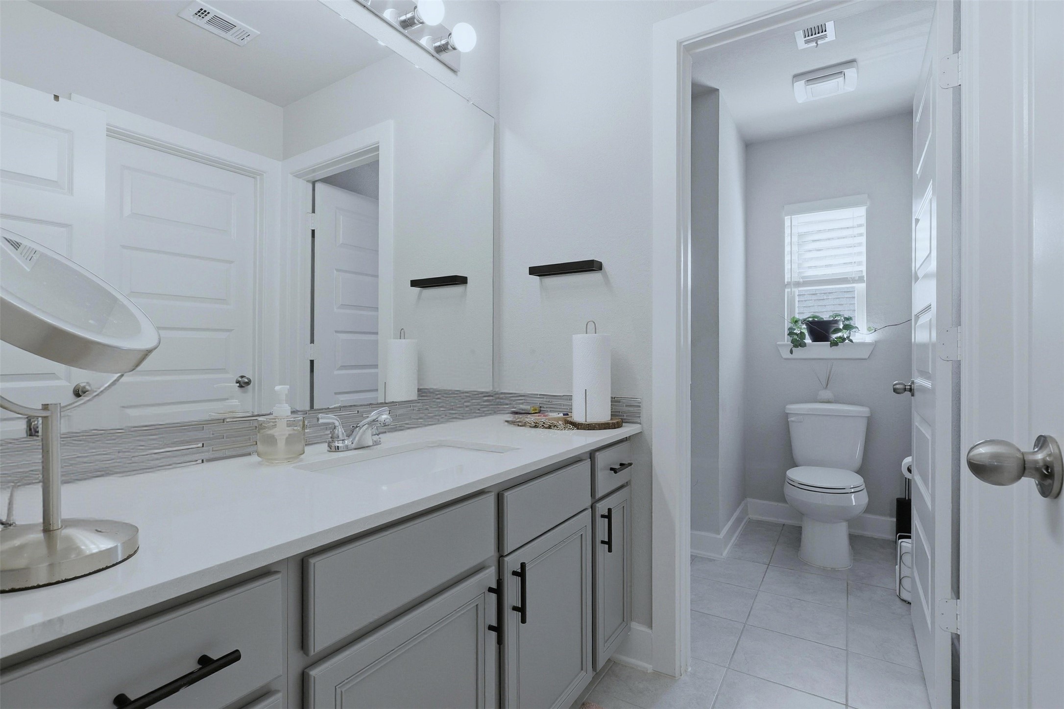 15133 Mahogany Trail Conroe, TX 77302 - Photo 30 of 49 a bathroom with a sink a toilet and a mirror