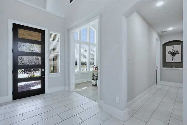 a view of an entryway with wooden floor and a living room