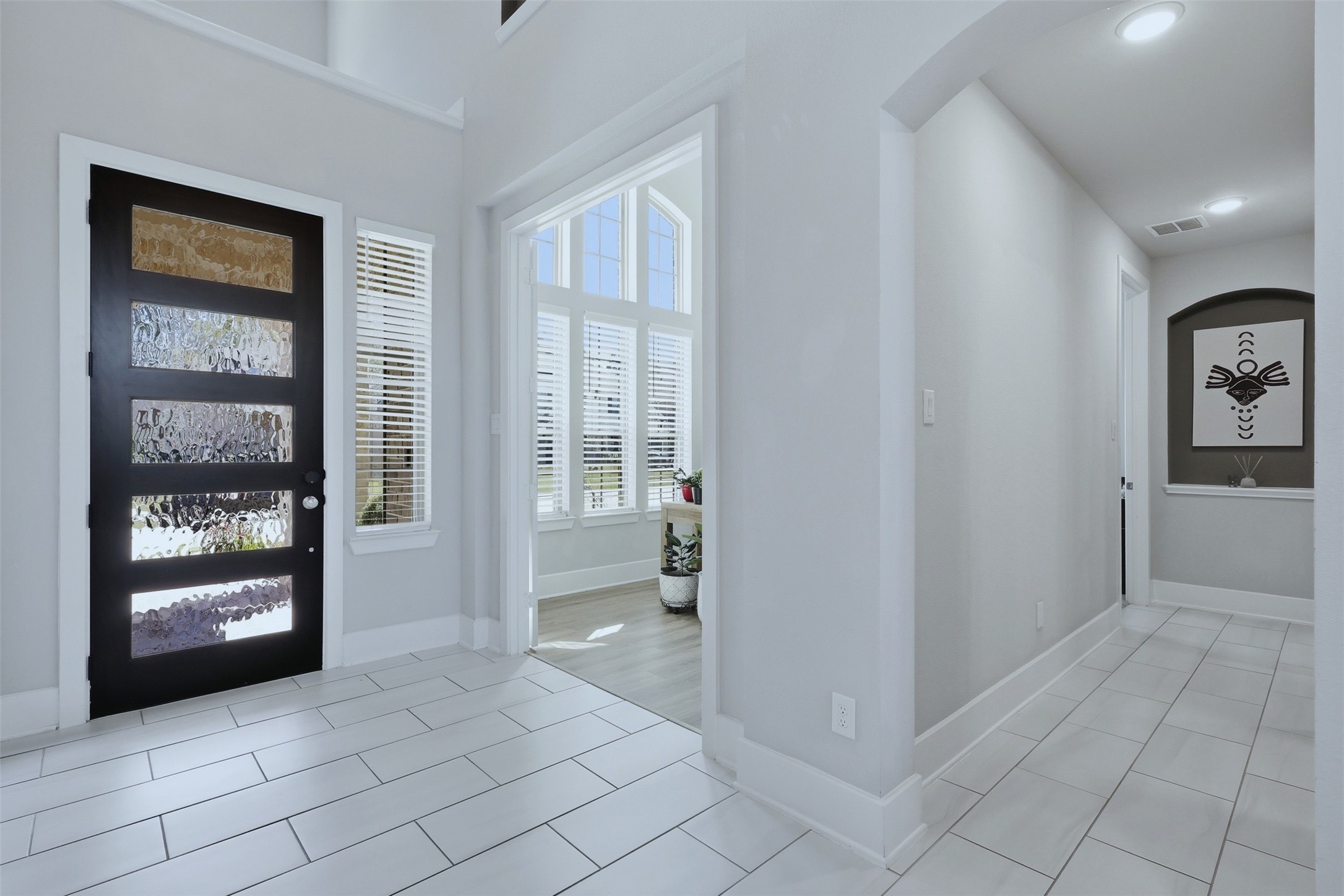 15133 Mahogany Trail Conroe, TX 77302 - Photo 3 of 49 a view of an entryway with wooden floor and a living room
