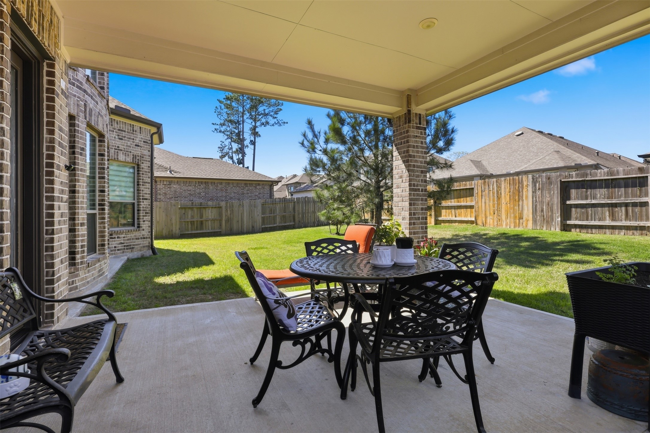15133 Mahogany Trail Conroe, TX 77302 - Photo 39 of 49 a view of a patio with table and chairs and potted plants