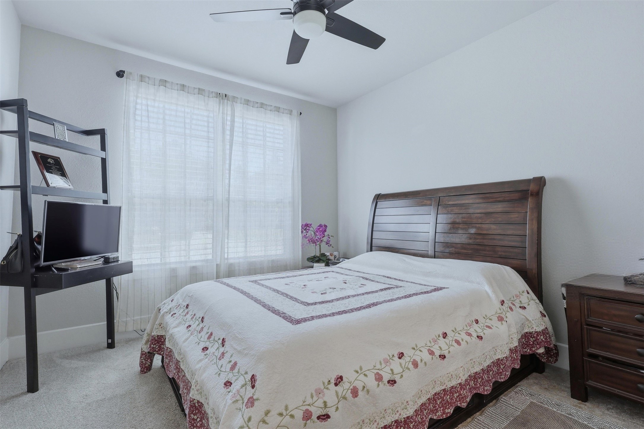 15133 Mahogany Trail Conroe, TX 77302 - Photo 6 of 49 a bedroom with a bed and a flat tv screen