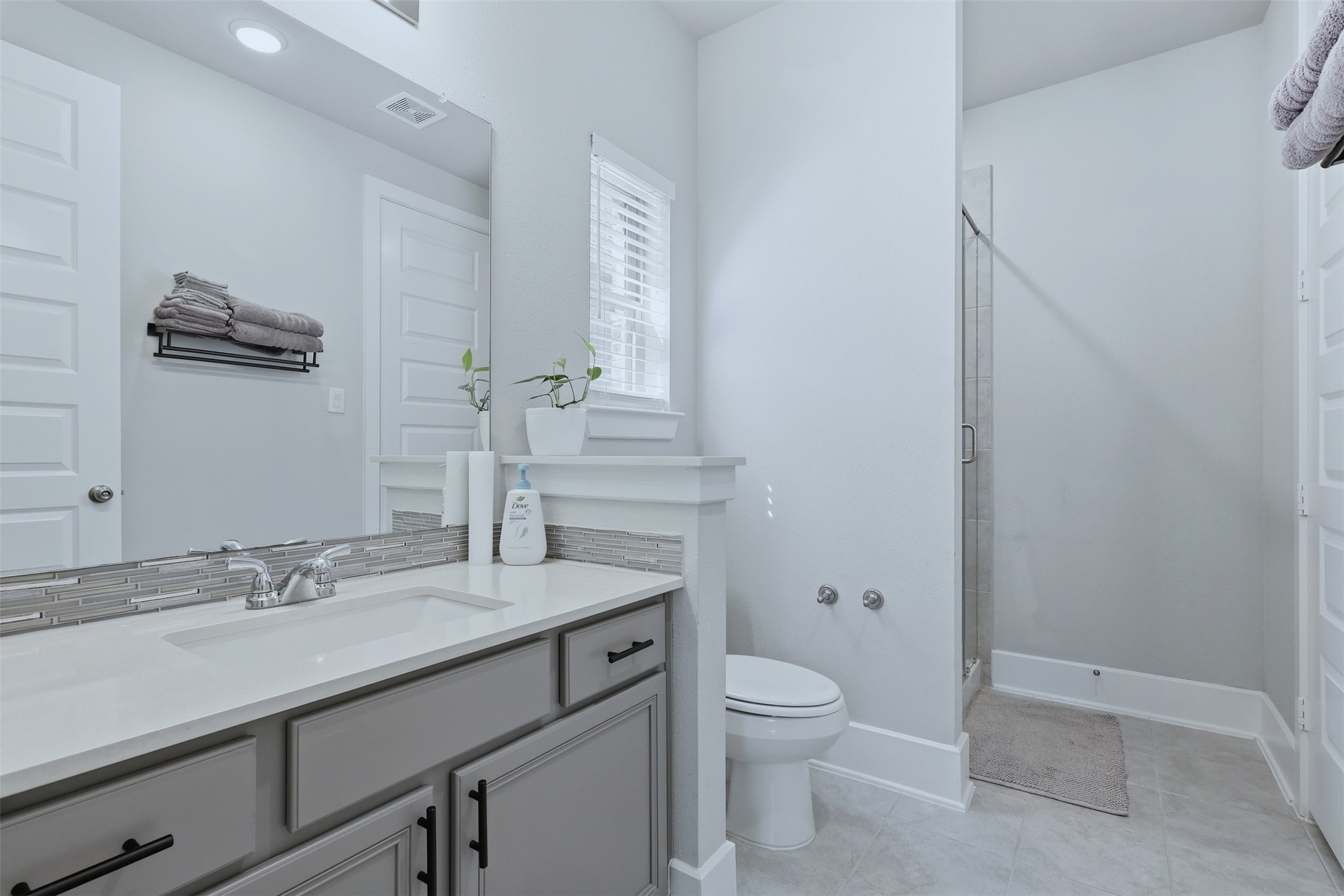 15133 Mahogany Trail Conroe, TX 77302 - Photo 7 of 49 a bathroom with a granite countertop sink a toilet and a mirror