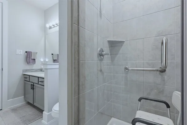 a bathroom with a granite countertop sink toilet and shower