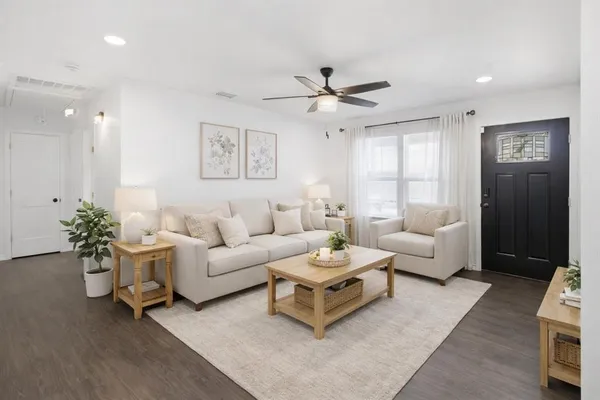 a living room with furniture and a large window