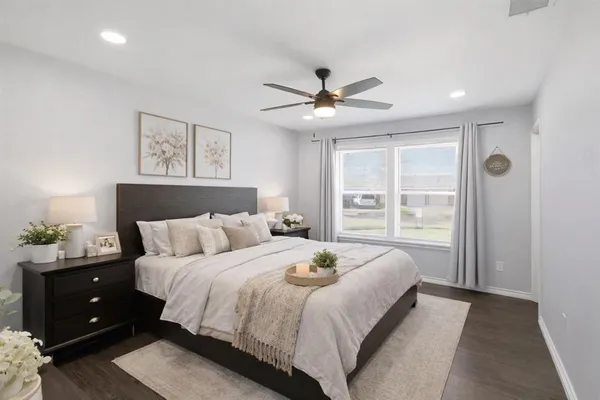 a bedroom with a large bed and a window