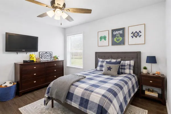 a bedroom with a bed and a flat screen tv
