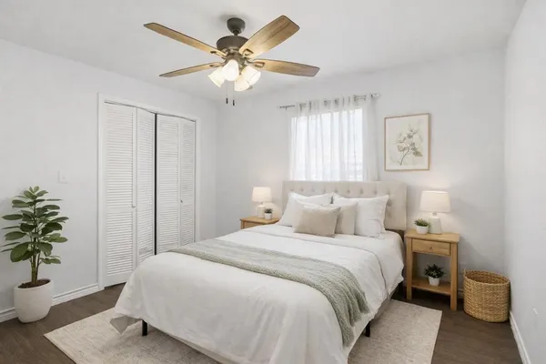 a bedroom with a bed and a potted plant