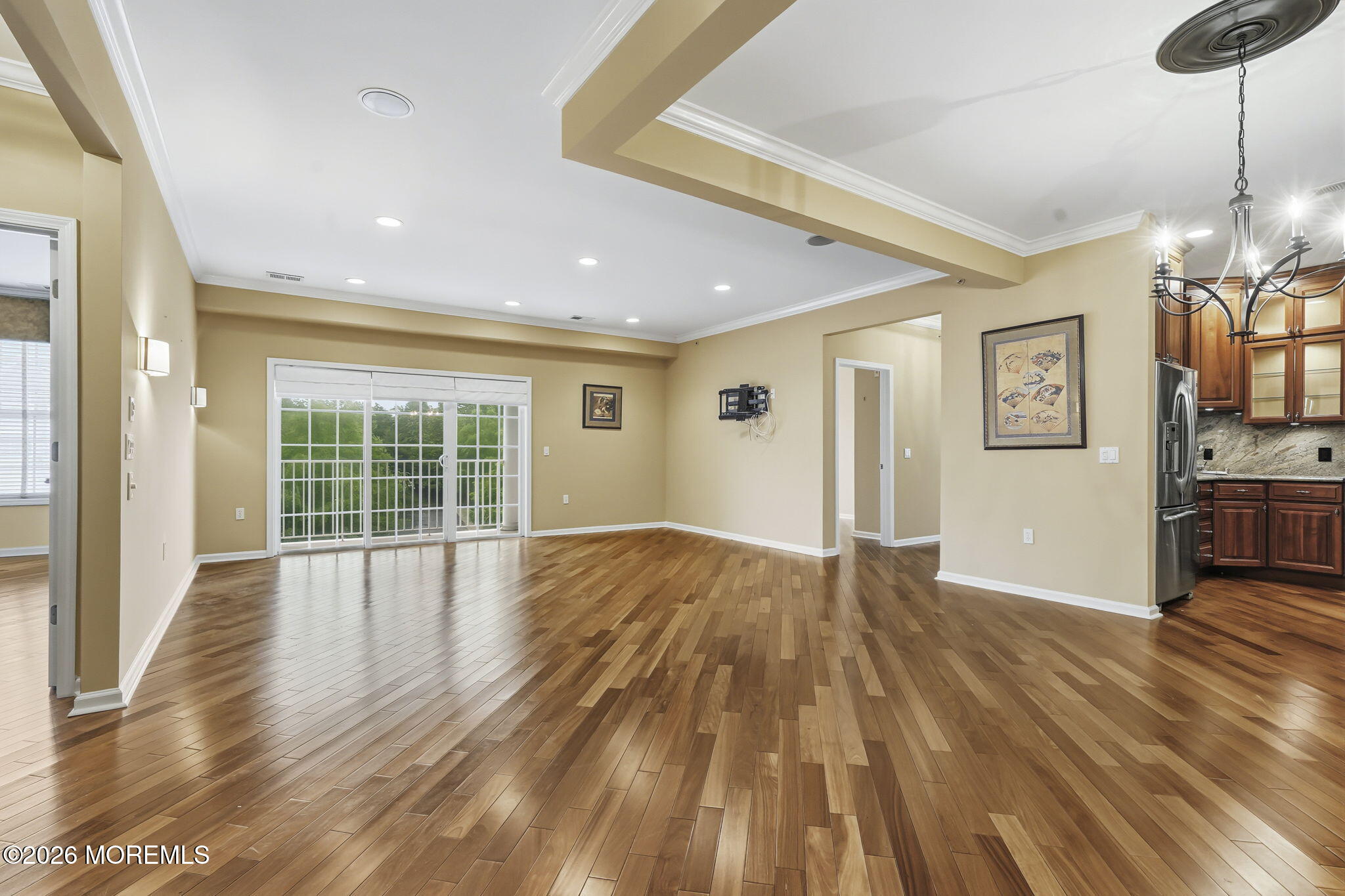 106 Potts Road Morganville, NJ 07751 - Photo 6 of 25 a view of empty room with wooden floor and fan