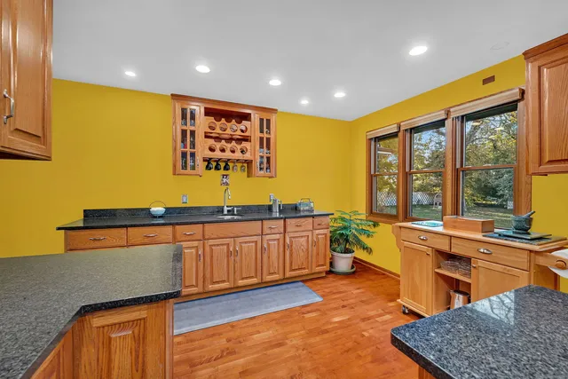a kitchen with stainless steel appliances granite countertop sink stove and granite counter top