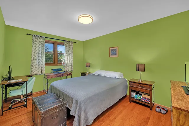 a bedroom with a bed and a desk