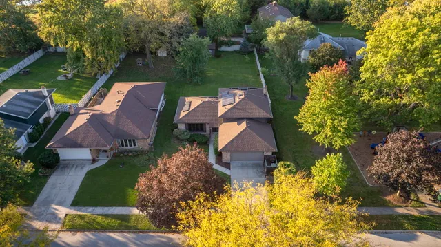 an aerial view of a house with a garden and swimming pool