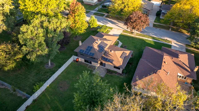 an aerial view of a house with a yard