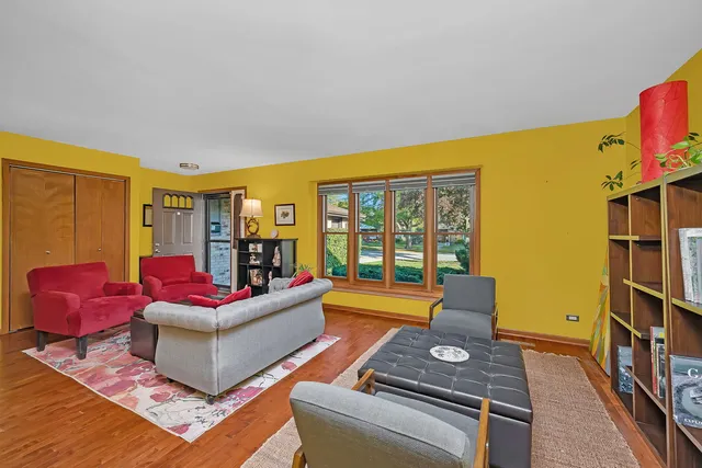 a living room with furniture and a floor to ceiling window