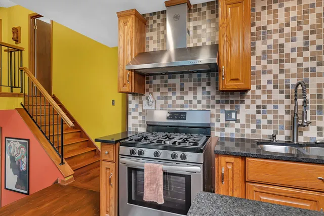 a kitchen with granite countertop a stove and a sink