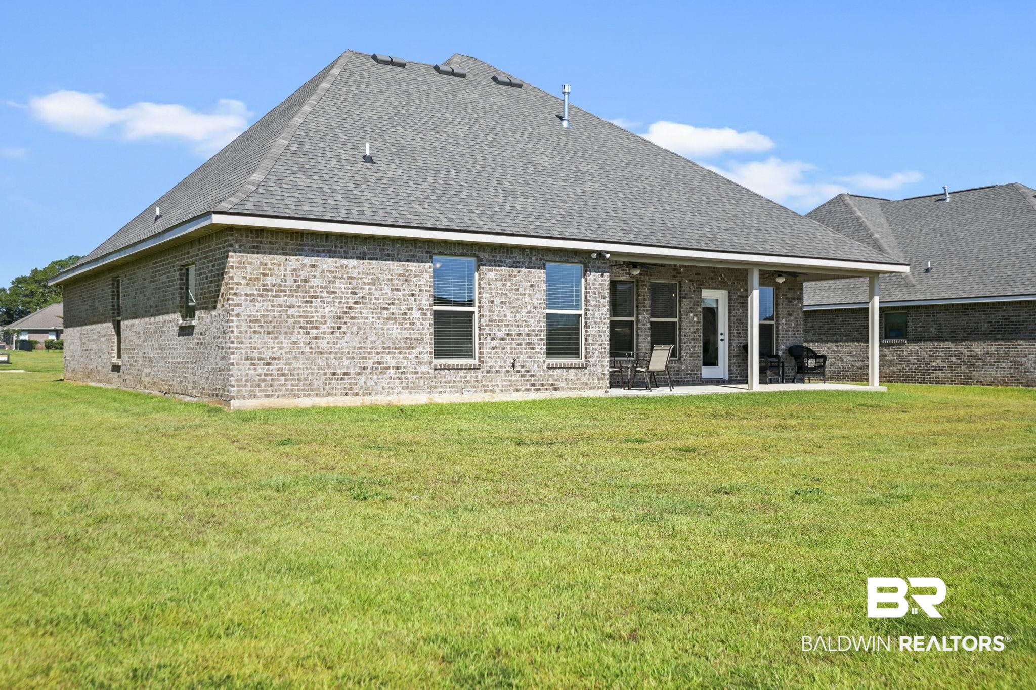 10140 Chipper Lane Foley, AL 36535 - Photo 45 of 72 Back of property featuring a patio area and a lawn