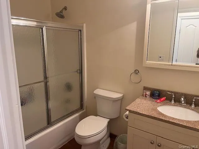 a white toilet sitting next to a bathroom sink