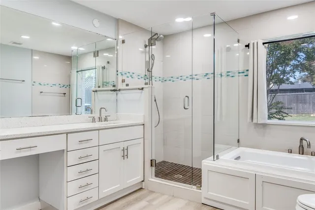a bathroom with a double vanity sink mirror and shower