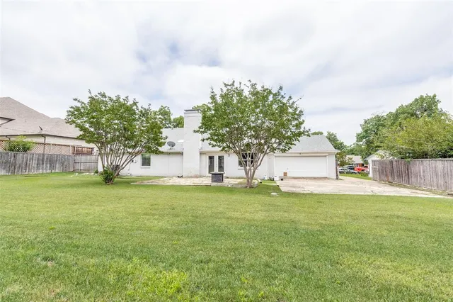 a house with a garden and trees