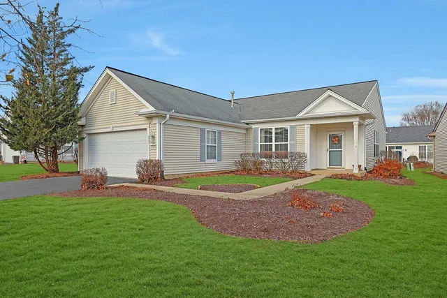 a front view of a house with a yard and porch