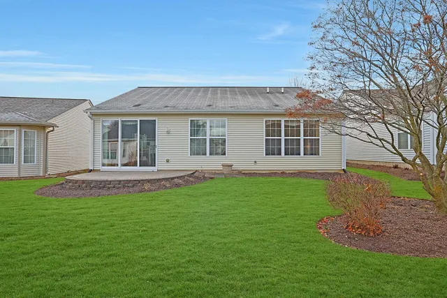 a view of a house with a backyard