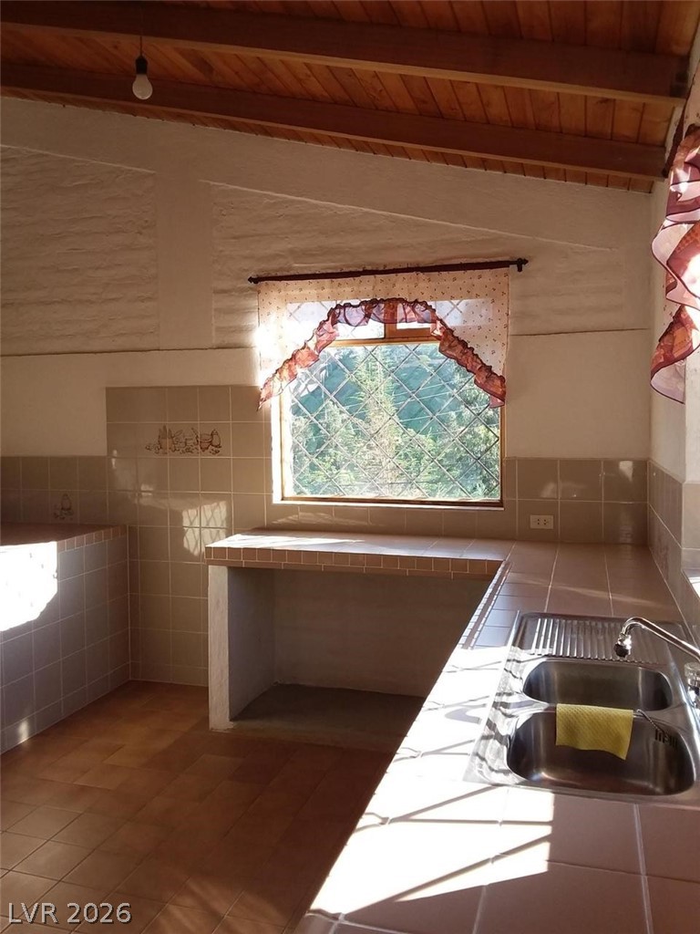 970 La Rabija Shermans Dale, OS 17090 - Photo 12 of 18 Sun-drenched kitchen with natural wood beamed ceilings and ample counter space.