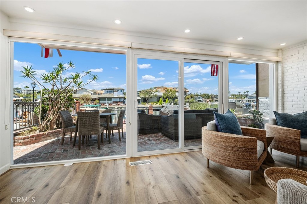 3810 Channel Place Newport Beach, CA 92663 - Photo 14 of 43 a living room with furniture potted plant floor to ceiling window and wooden floor