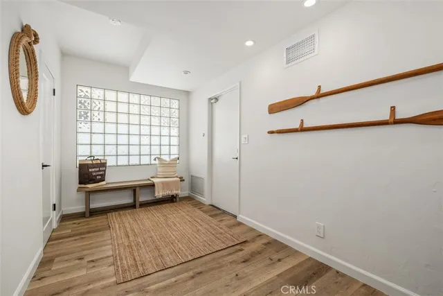 a view of a room with racks on the wall and a window