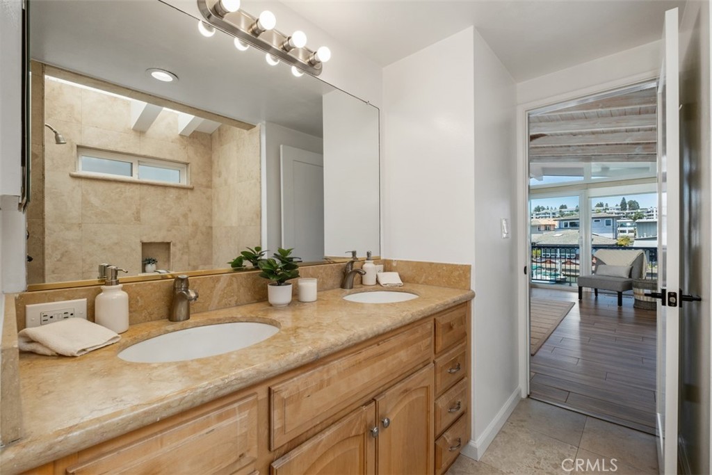 3810 Channel Place Newport Beach, CA 92663 - Photo 28 of 43 a bathroom with a granite countertop sink a toilet and a mirror