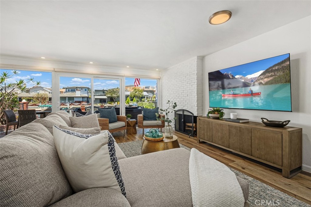 3810 Channel Place Newport Beach, CA 92663 - Photo 7 of 43 a living room with furniture and a flat screen tv