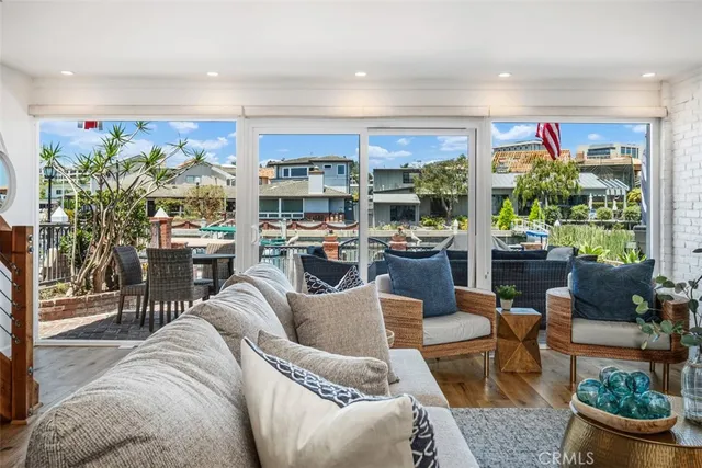 a living room with furniture a dining table and a floor to ceiling window