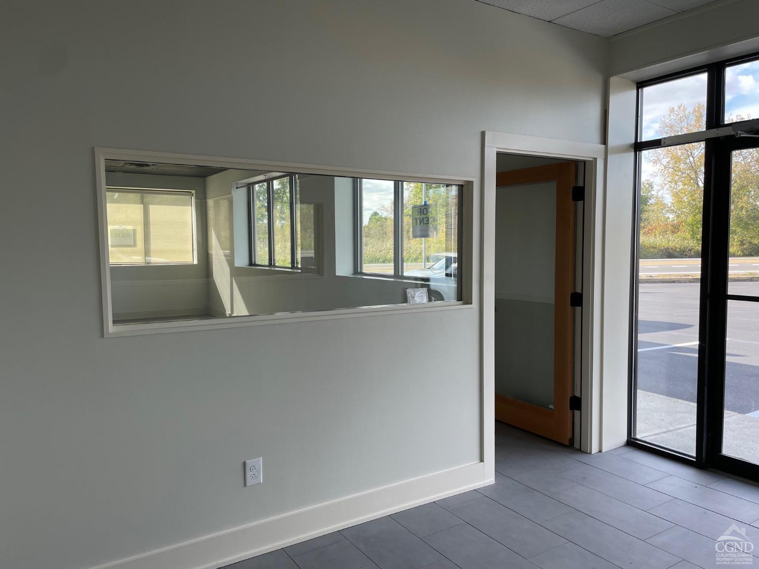 8 County Route 82 Hudson, NY 12534 - Photo 3 of 9 an empty room with large windows and city view