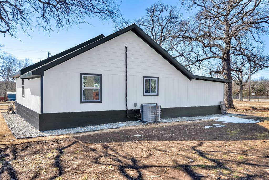 909 East Sears Street Denison, TX 75021 - Photo 21 of 24 View of side of home featuring a cooling unit