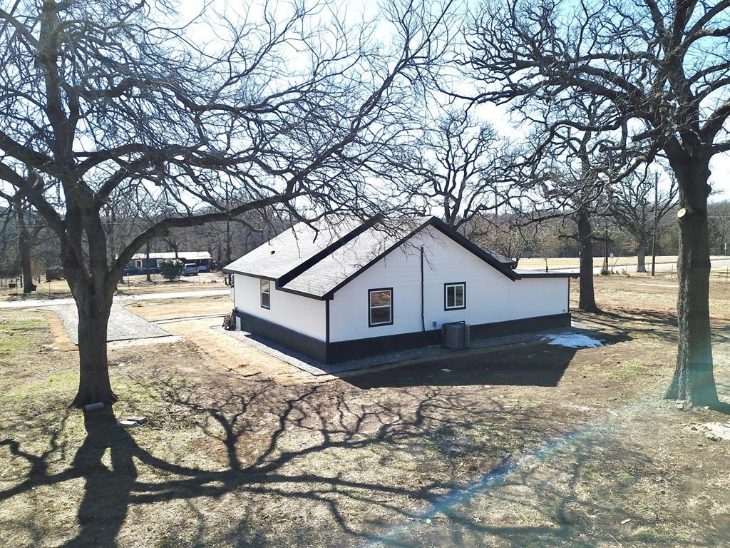 909 East Sears Street Denison, TX 75021 - Photo 22 of 24 View of side of property featuring a cooling unit