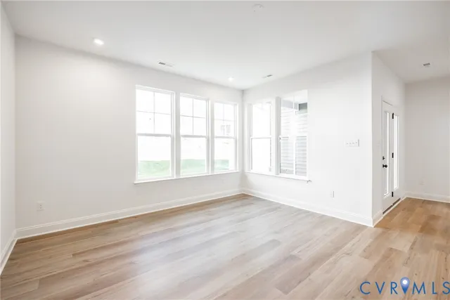 a view of a room with wooden floor