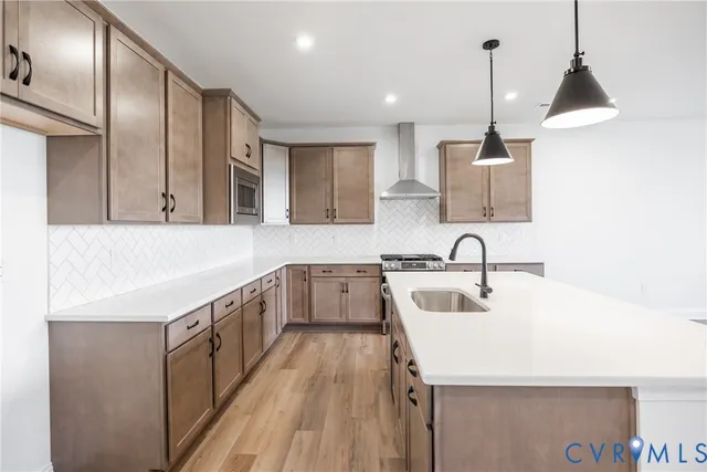 a kitchen with a sink a stove and a microwave