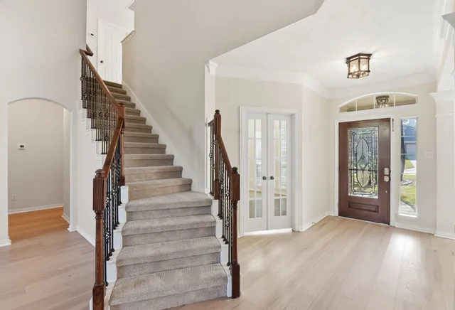 a view of entryway and hall with wooden floor