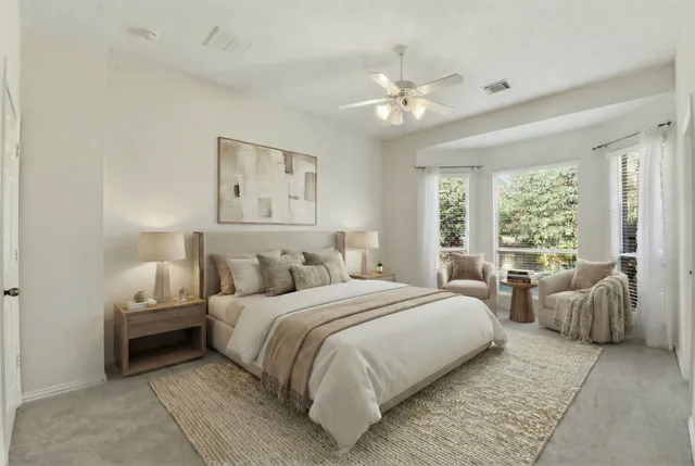 a bedroom with a large bed and a chandelier