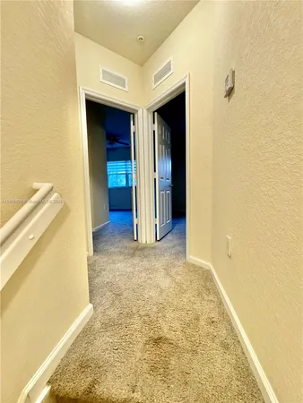 an empty room with a ceiling fan and a window
