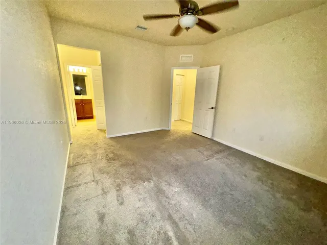 an empty room with a empty space and a ceiling fan
