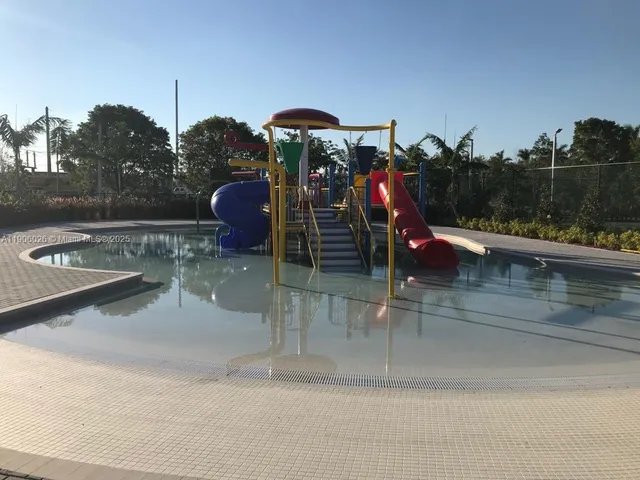 a view of a kitchen with kitchen appliances and a sink