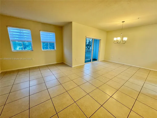 a view of a kitchen with granite countertop sink and cabinets