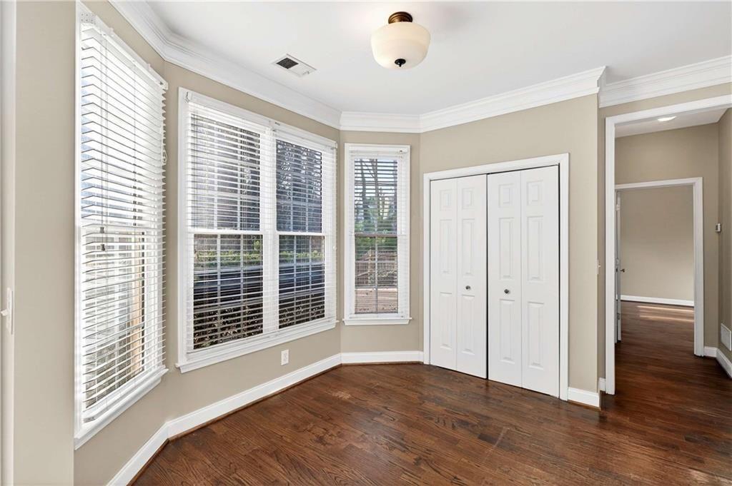 5731 Vinings Retreat Way Southwest Mableton, GA 30126 - Photo 11 of 32 a view of an empty room with wooden floor and a window