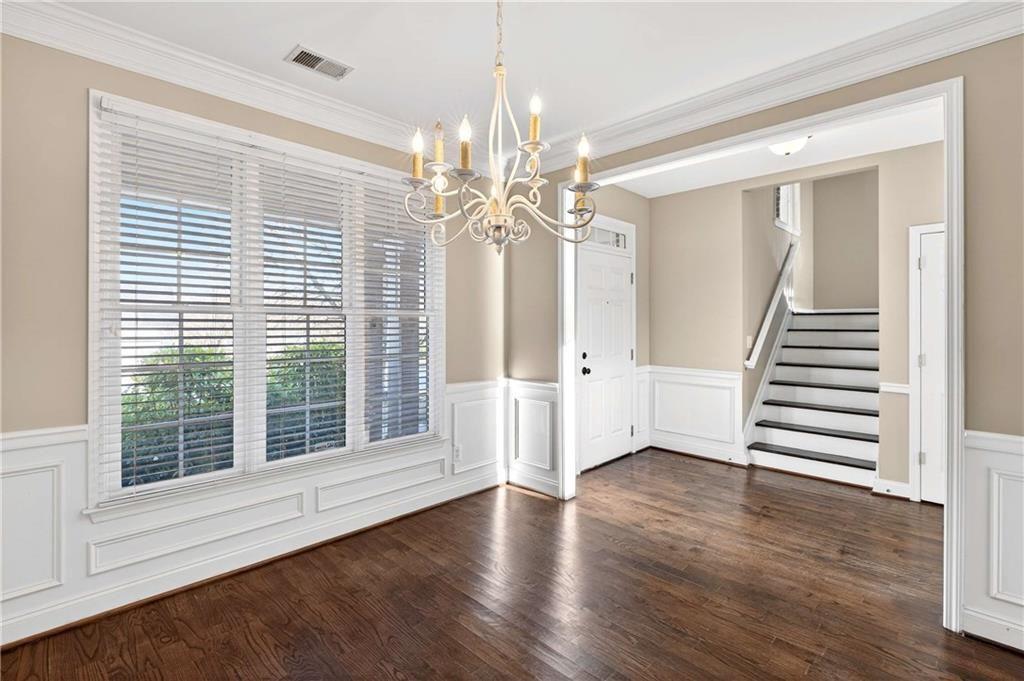 5731 Vinings Retreat Way Southwest Mableton, GA 30126 - Photo 2 of 32 a view of an empty room with wooden floor and a window