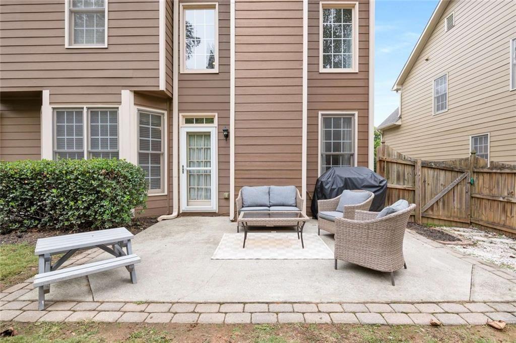 5731 Vinings Retreat Way Southwest Mableton, GA 30126 - Photo 24 of 32 a view of a patio with couches table and chairs and potted plants