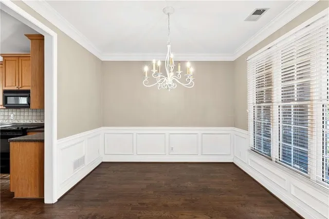 a view of a livingroom with wooden floor and staircase