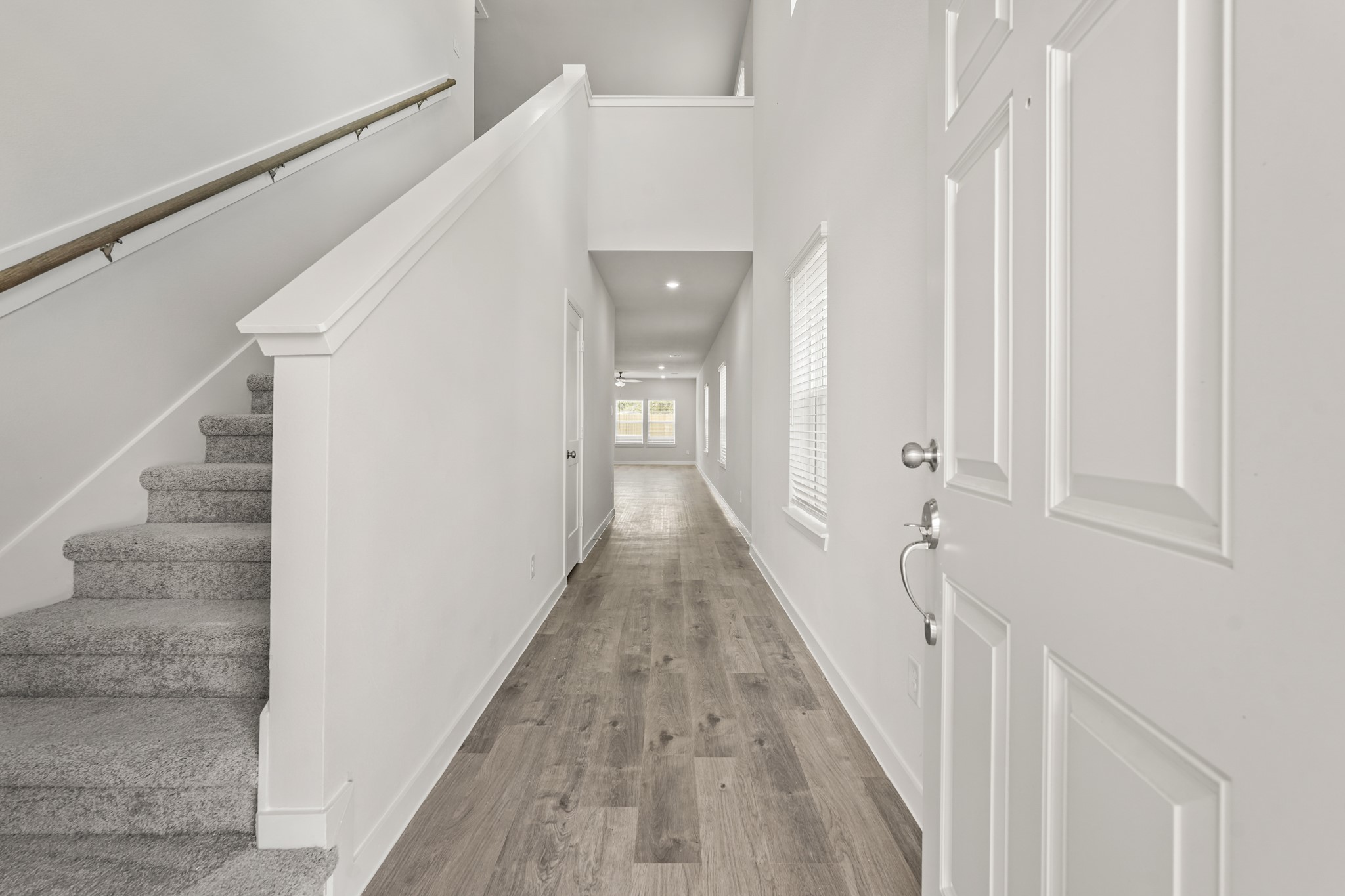 213 Spring Drive Hockley, TX 77447 - Photo 3 of 26 a view of a hallway with white walls and stairs